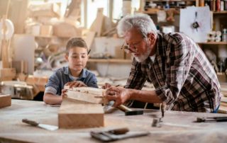 Grandson and Grandfather in a garage woodshop - Garage Harmony