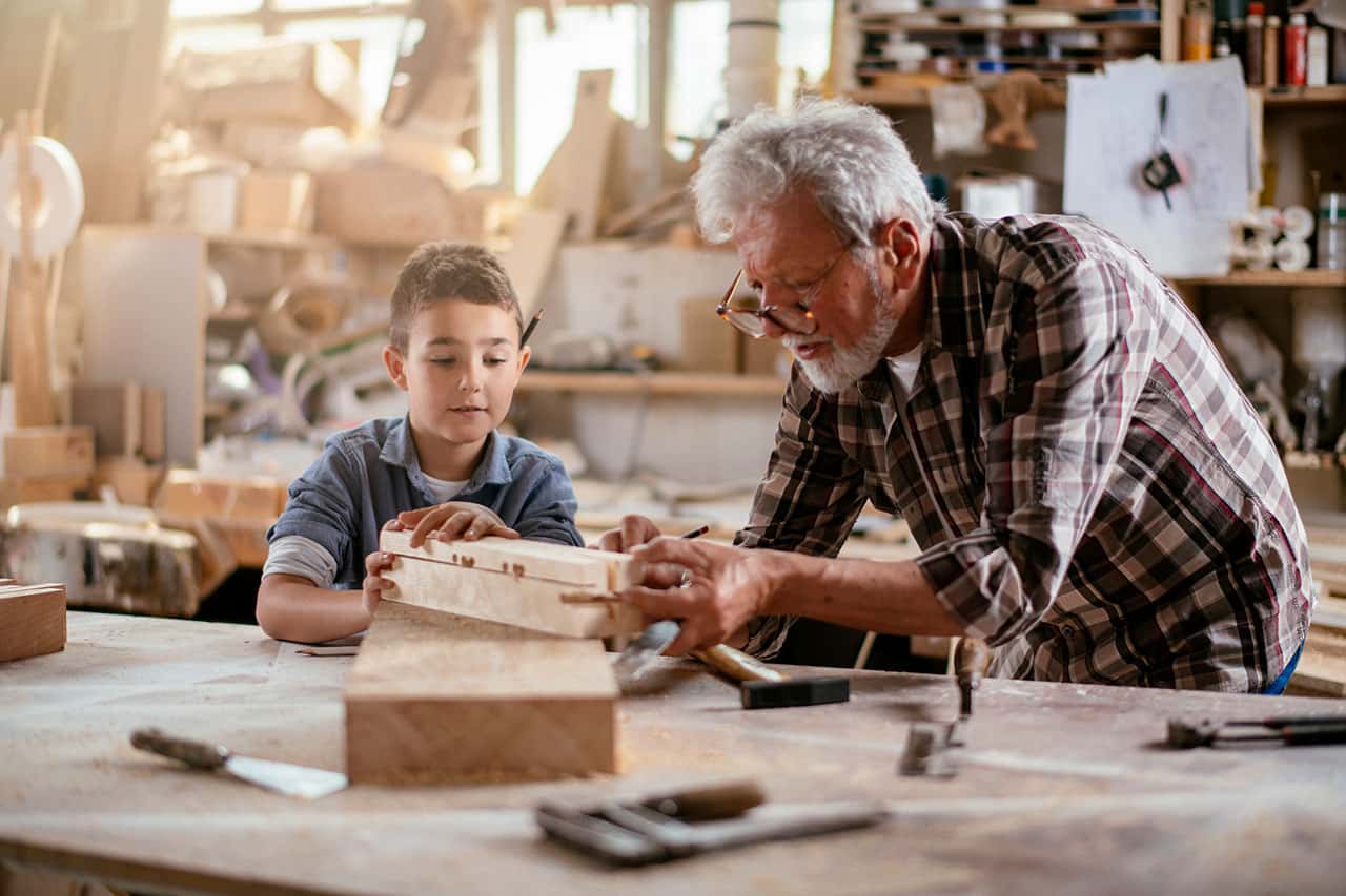 Grandson and Grandfather in a garage woodshop - Garage Harmony