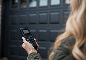 woman holding garage door remote
