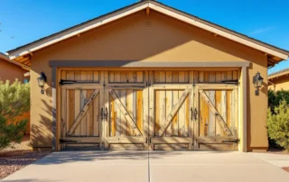 Wooden garage door with sun-faded paint and cracking from Central Oregon UV exposure